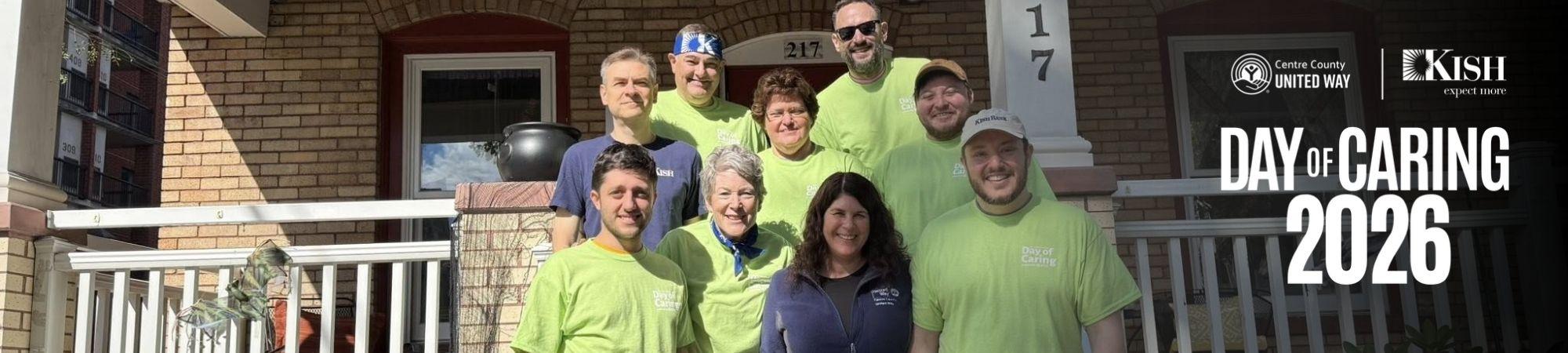Team of volunteers in front of house