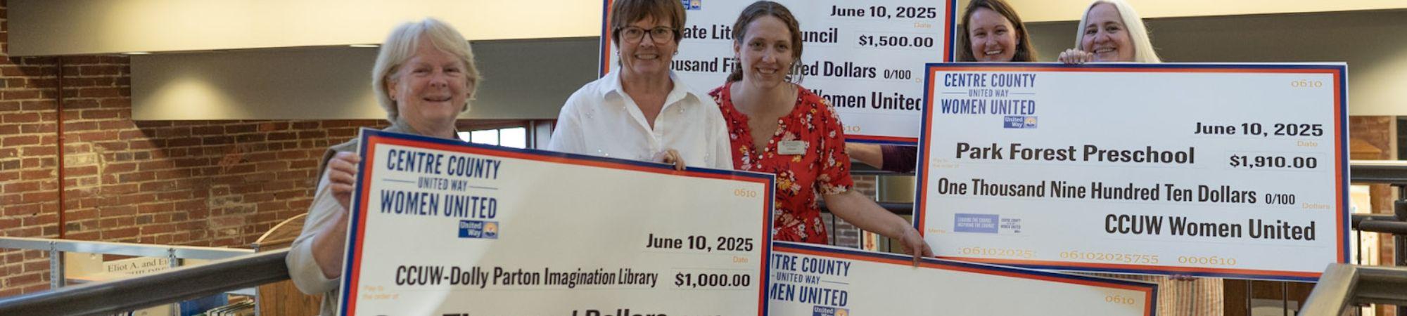 Grantees holding big checks